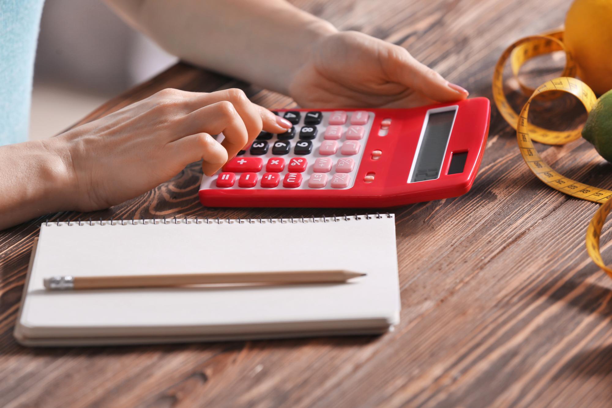 Close-up of hands calculating expenses